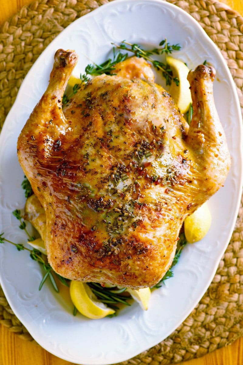 Roasted Chicken with Lemon Curd recipe from RecipeGirl.com #roasted #chicken #lemon #curd #lemoncurd #roastedchicken #recipe #RecipeGirl Roasted Chicken with Lemon Curd on white platter