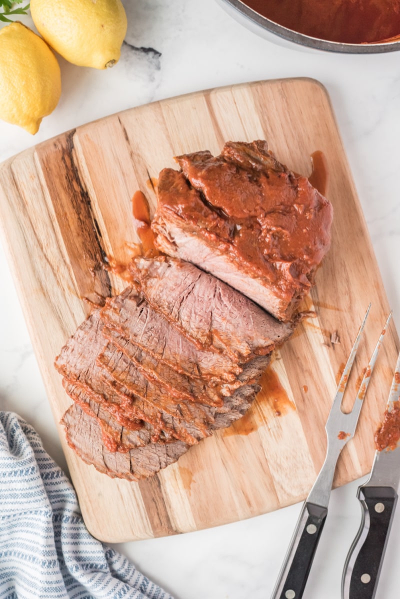 sicilian pot roast on cutting board cut into slices