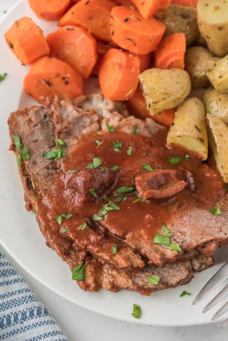 pot roast served with carrots and potatoes
