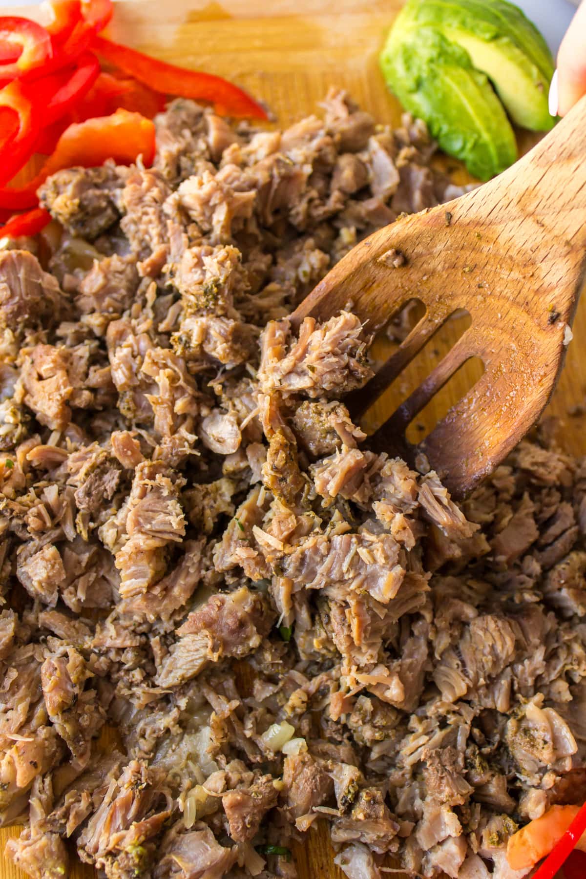 spoon with chopped up carnitas on board