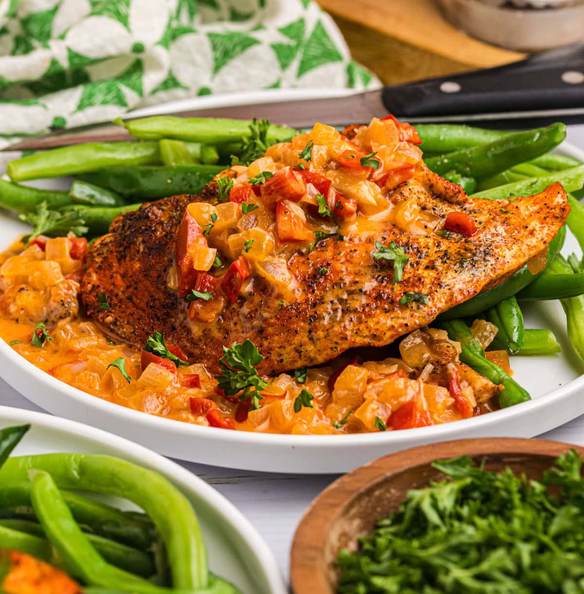 smothered chicken on plate with green beans