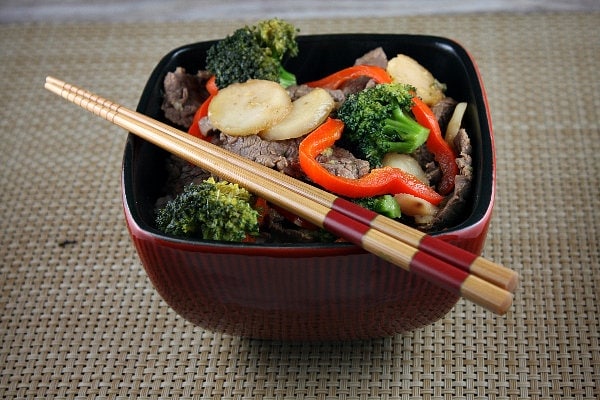 Stir Fried Beef and Broccoli Stir Fried Beef and Broccoli with Orange Sesame Sauce in bowl with chopsticks
