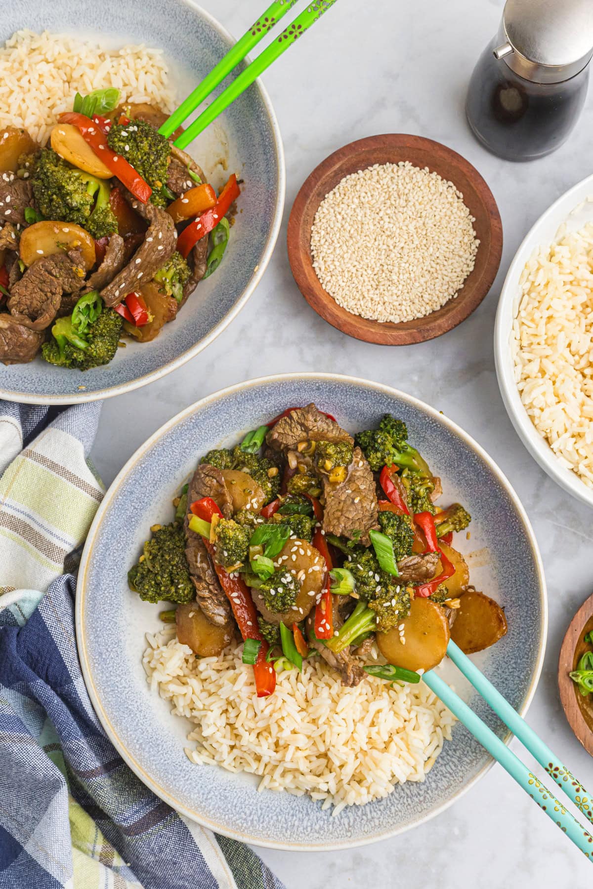 servings of stir fried beef and broccoli on plates