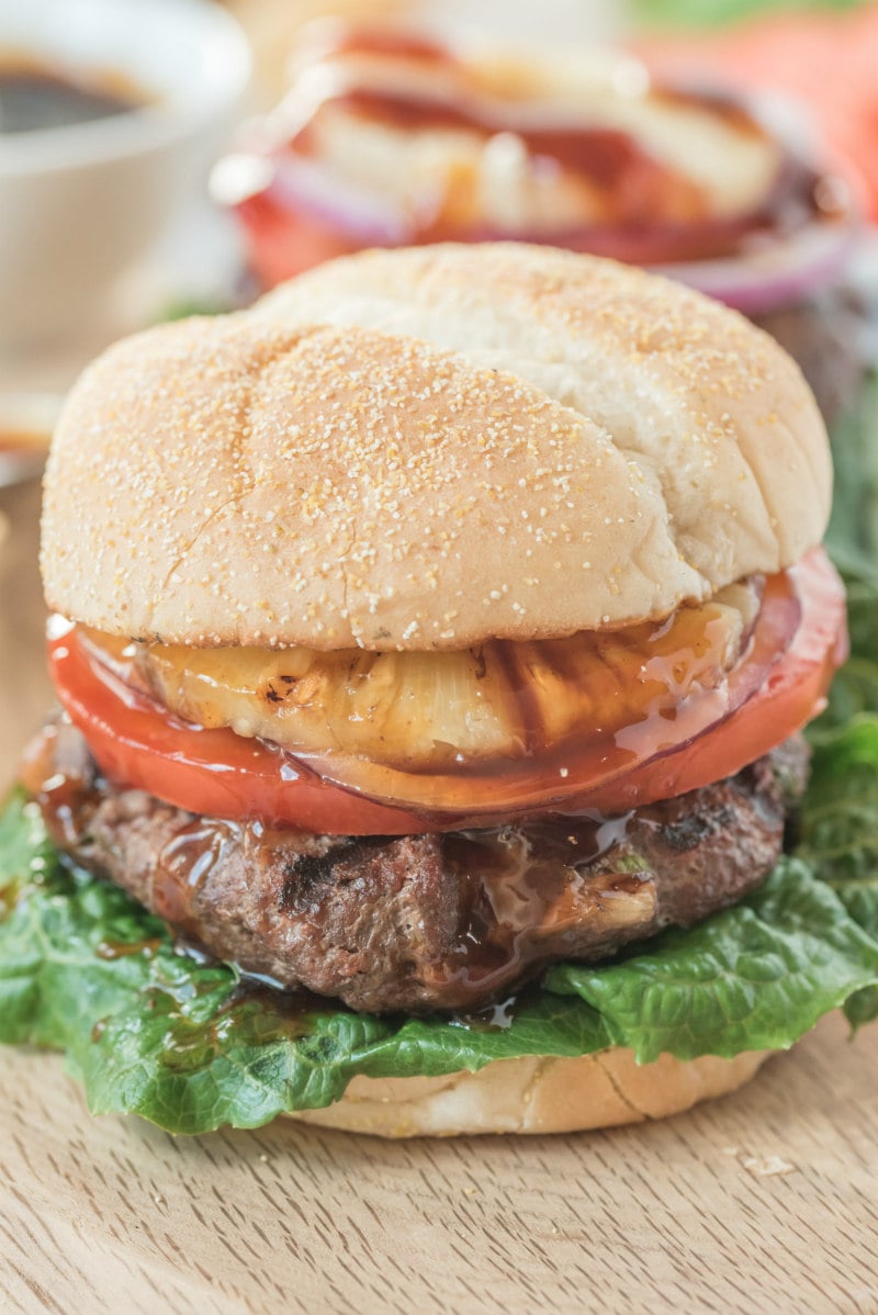 Teriyaki Burgers recipe from RecipeGirl.com #teriyaki #burger #burgers #recipe #RecipeGirl teriyaki burger sitting on a wooden board
