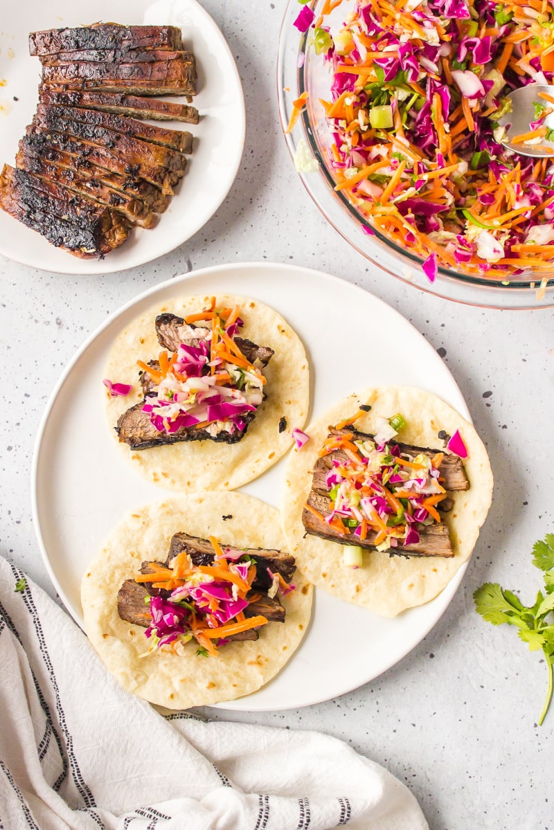 three open faced thai beef tacos on plate