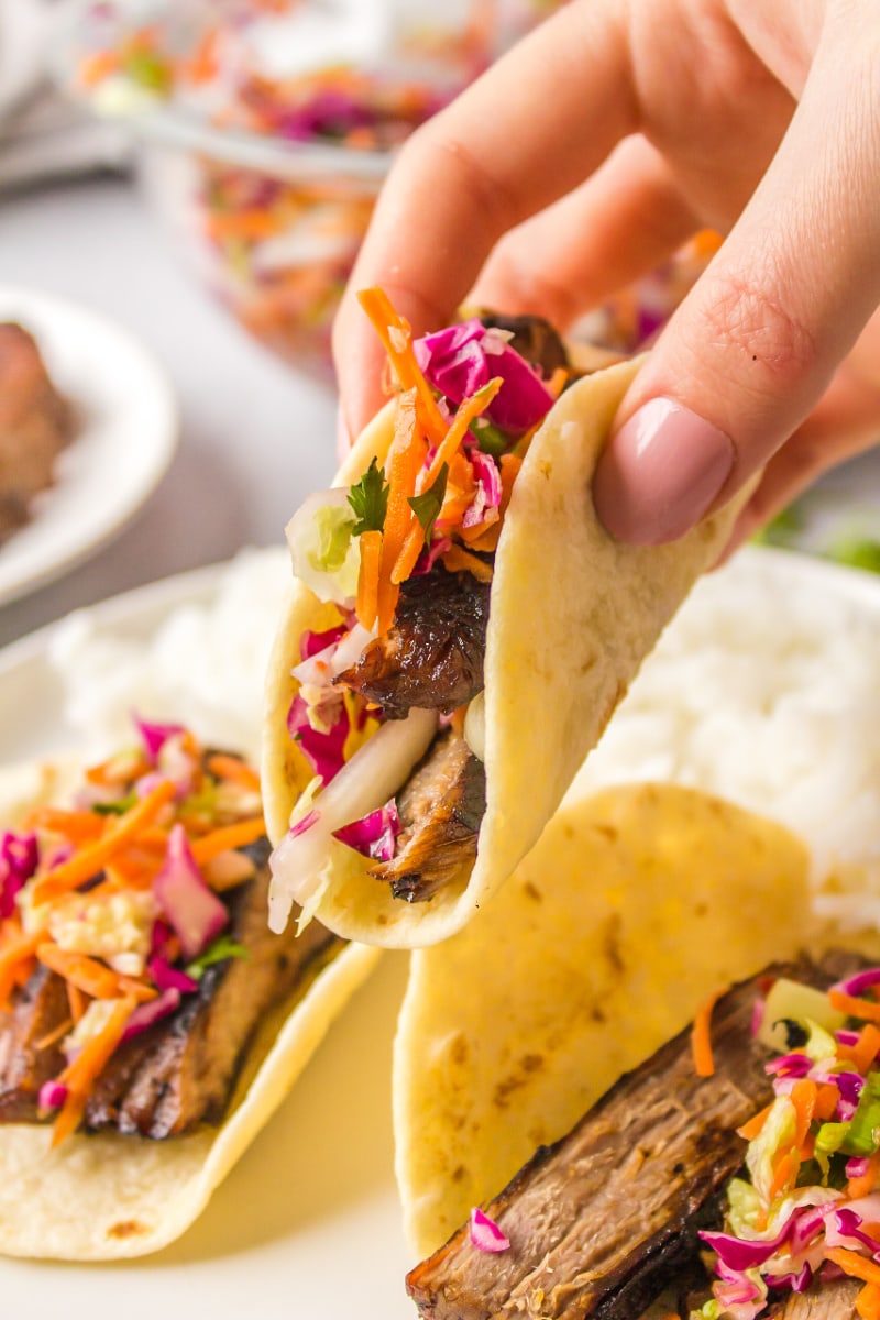 hand holding thai beef taco