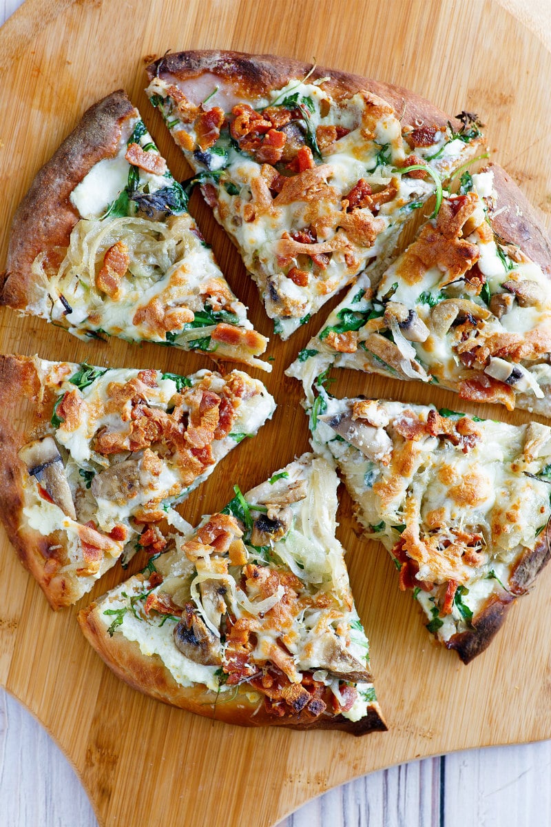 overhead shot of white pizza sliced on a cutting board