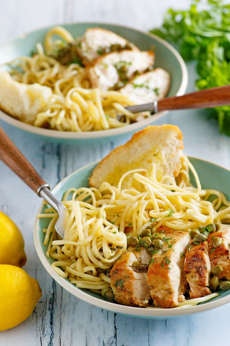 Chicken with lemon caper sauce served over pasta