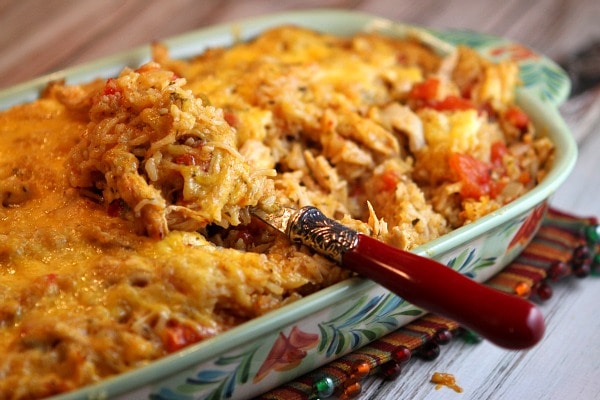 tex mex chicken and rice casserole in a casserole dish with a spoon