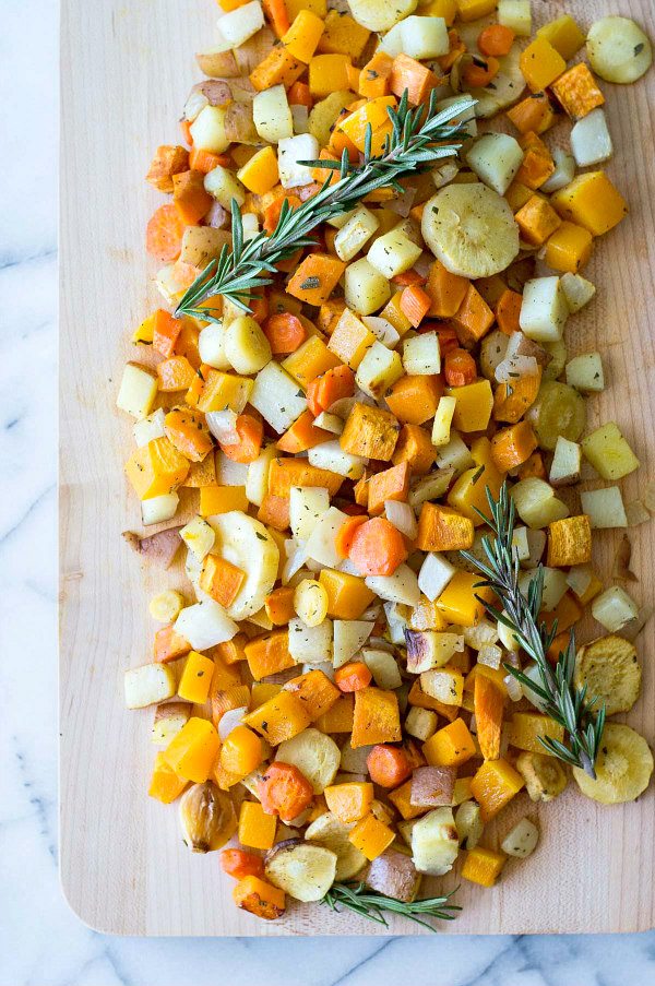 Roasted Autumn Vegetables recipe from RecipeGirl.com Roasted Autumn Vegetables on board topped with fresh rosemary