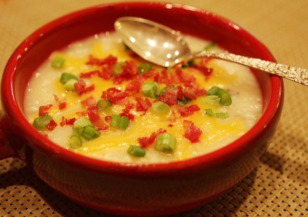bowl of baked potato and bacon soup with a spoon