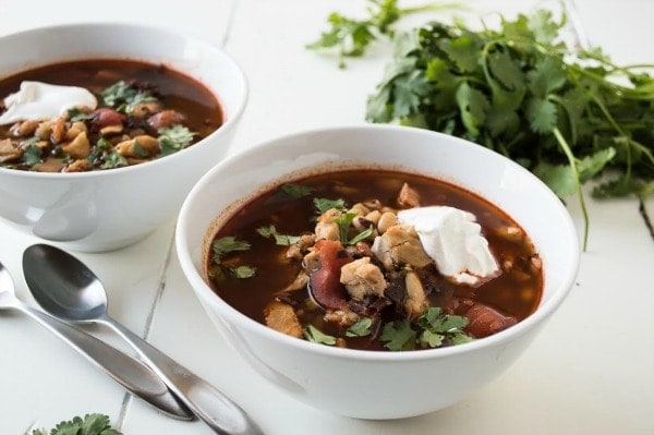 Chipotle Chicken and Tomato Soup recipe from RecipeGirl.com #chipotle #tomatosoup #comfortfood #soup #recipegirl Chipotle Chicken Tomato Soup in two white bowls