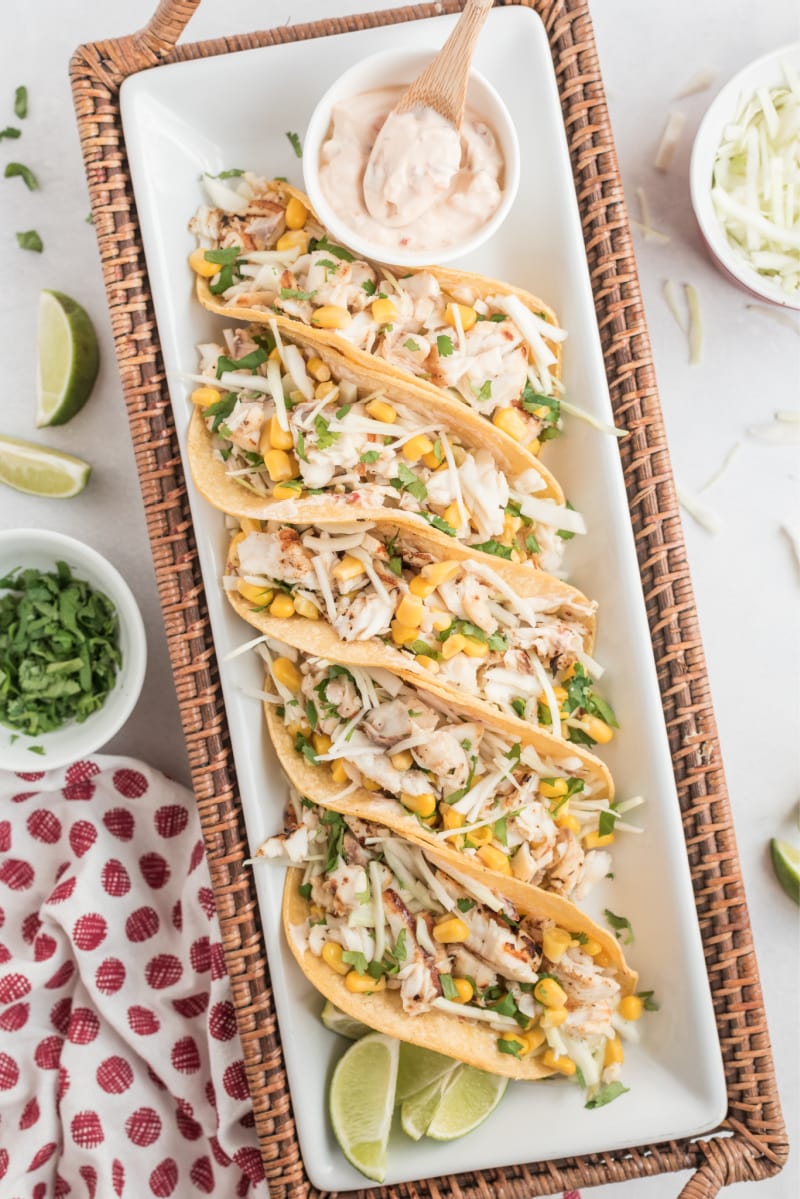 tacos nestled on a long white platter