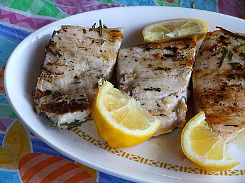 grilled swordfish with rosemary and lemon wedges