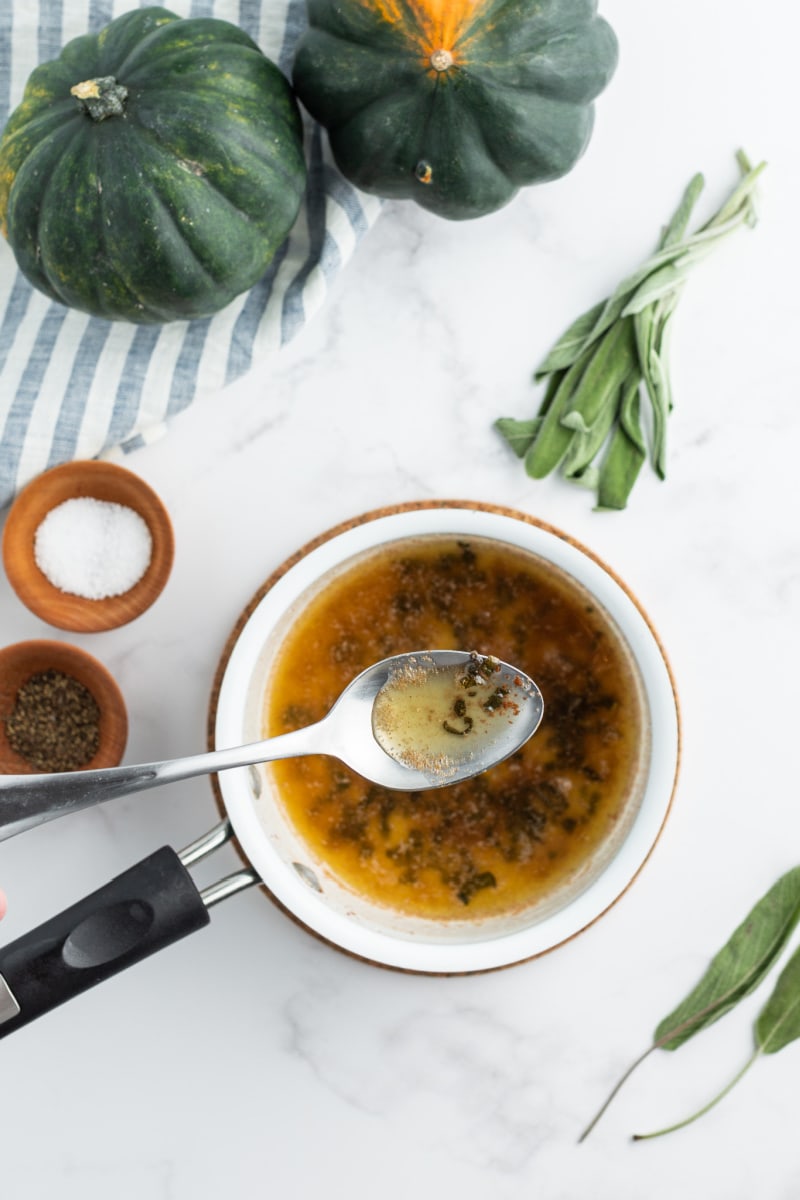 brown butter and sage in a white bowl with spoon