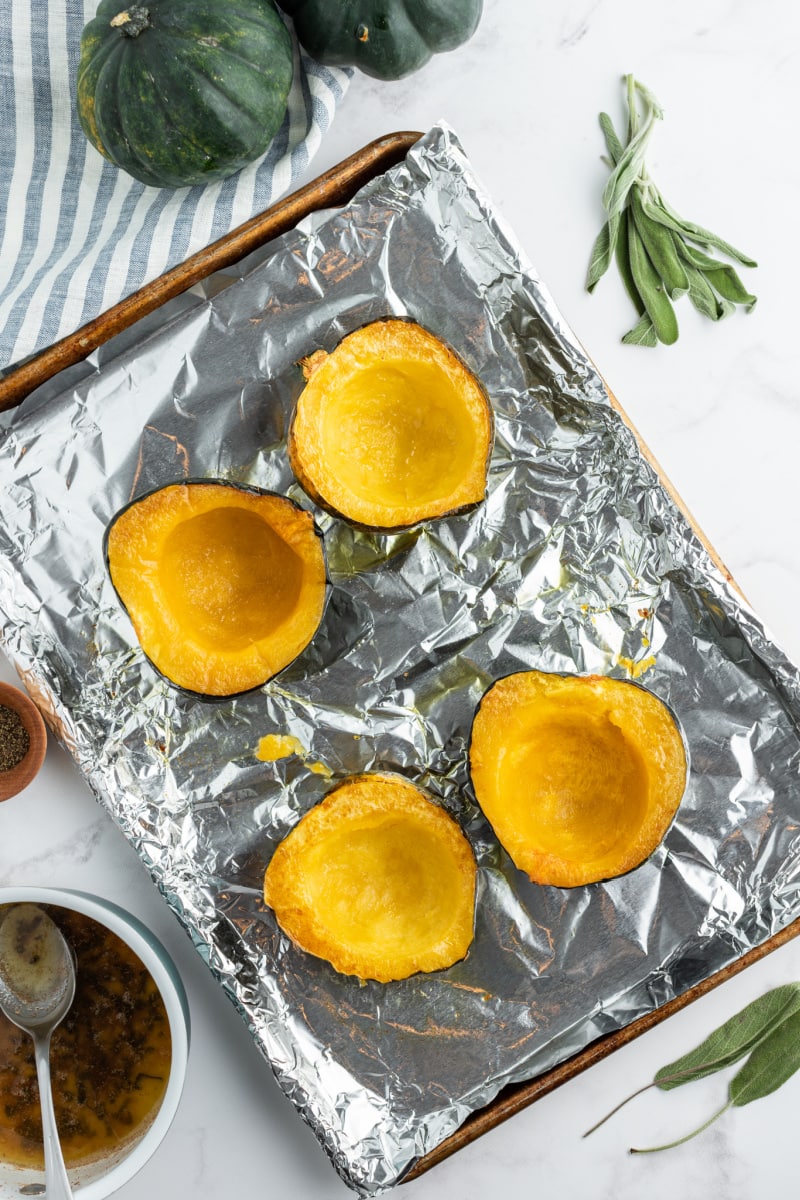 acornsquash on a baking sheet ready for oven