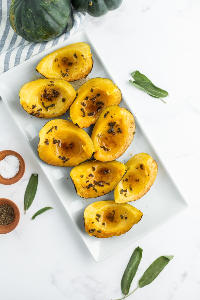 roasted winter squash wedges on a white platter