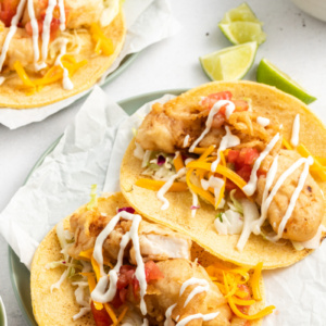 two san diego style fish tacos on a plate