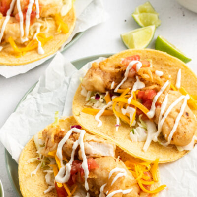 two san diego style fish tacos on a plate