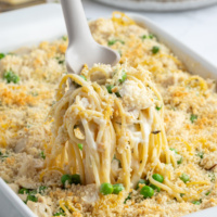 spooning out scoop of turkey tetrazzini from pan