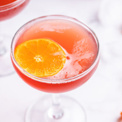 amaretto cranberry kiss cocktail with orange garnish