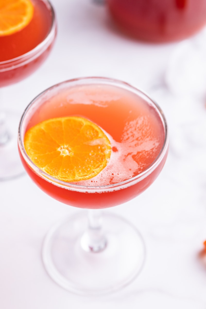 amaretto cranberry kiss cocktail with orange garnish