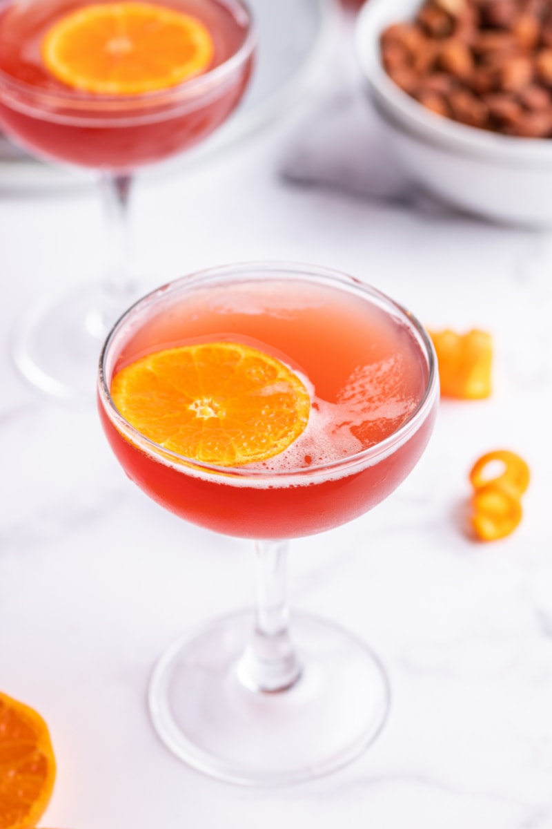 amaretto cranberry kiss cocktail garnished with orange
