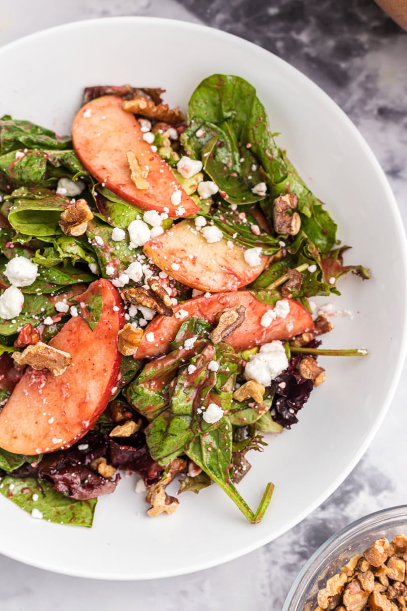 close up bowl of apple walnut salad