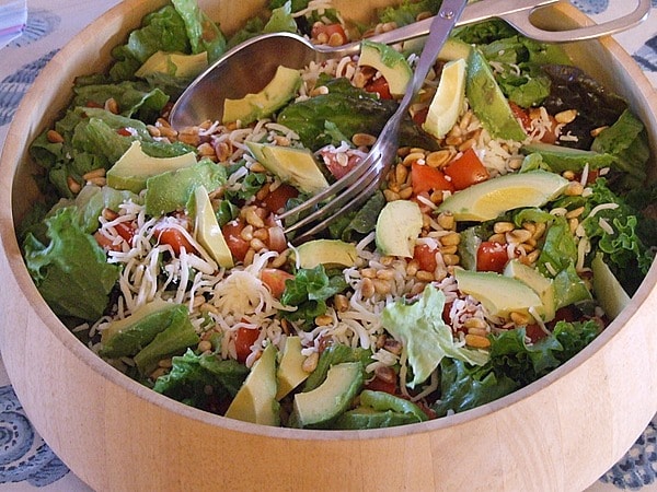 Avocado Pine Nut Salad in a wood bowl