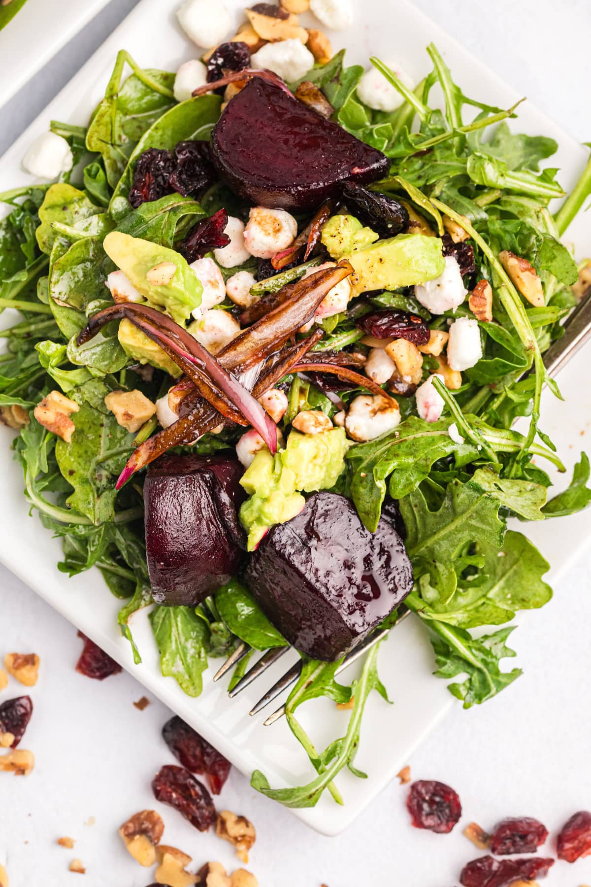 beet and goat cheese arugula salad on plate