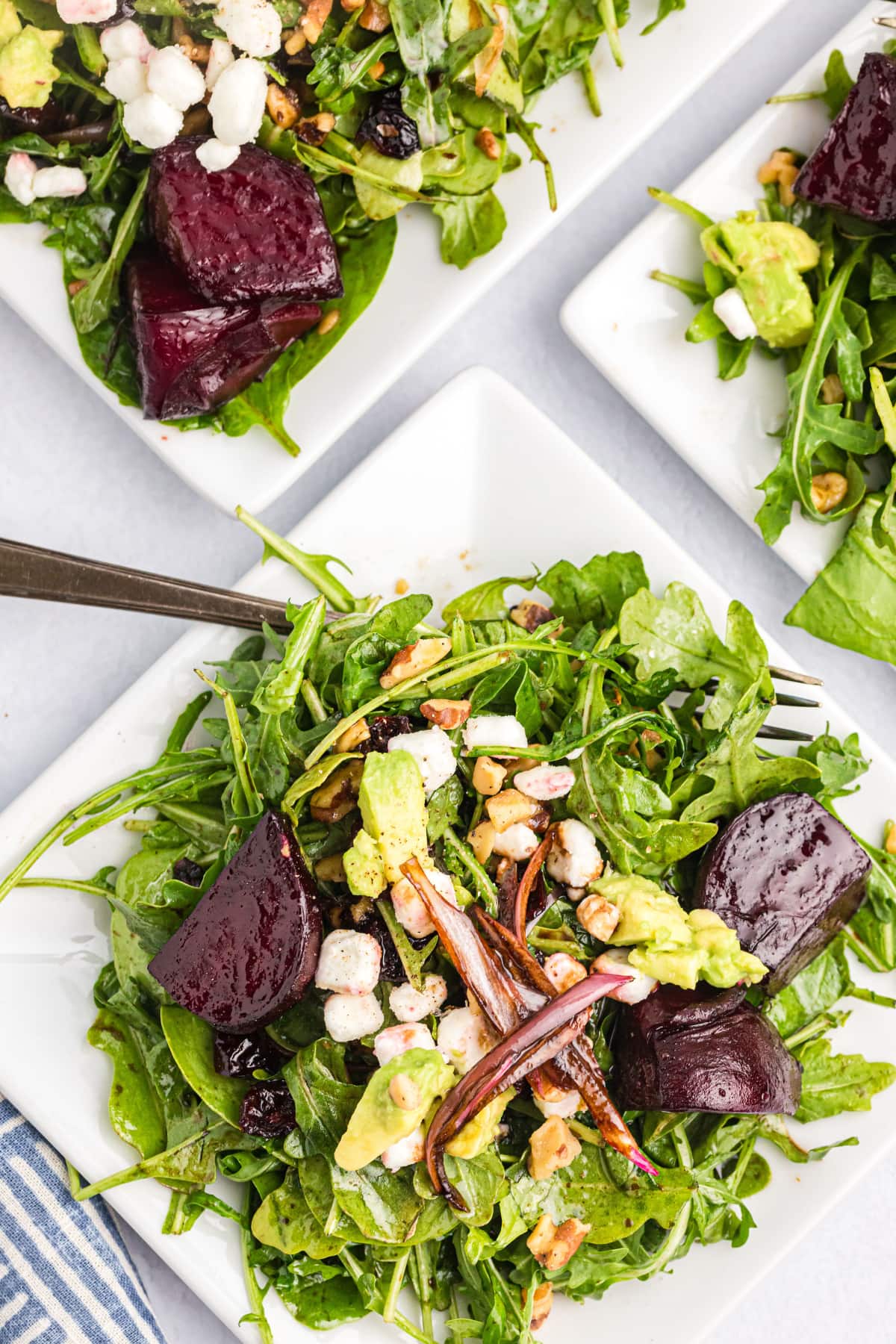 overheat shot of beet and goat cheese arugula salad