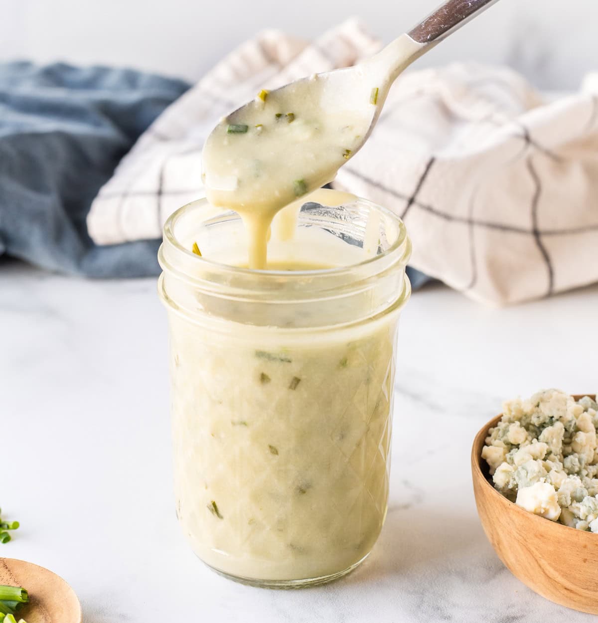 spoon in jar of blue cheese steak sauce