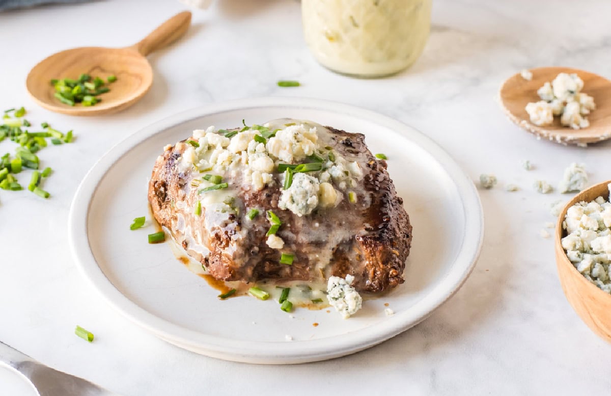 steak with blue cheese sauce drizzled on top