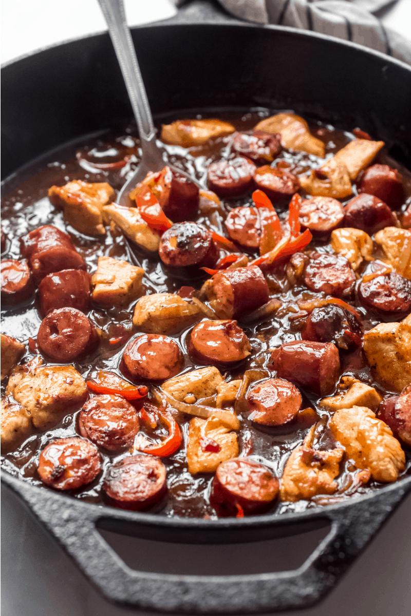 chicken and sausage mixture in a pan with sauce