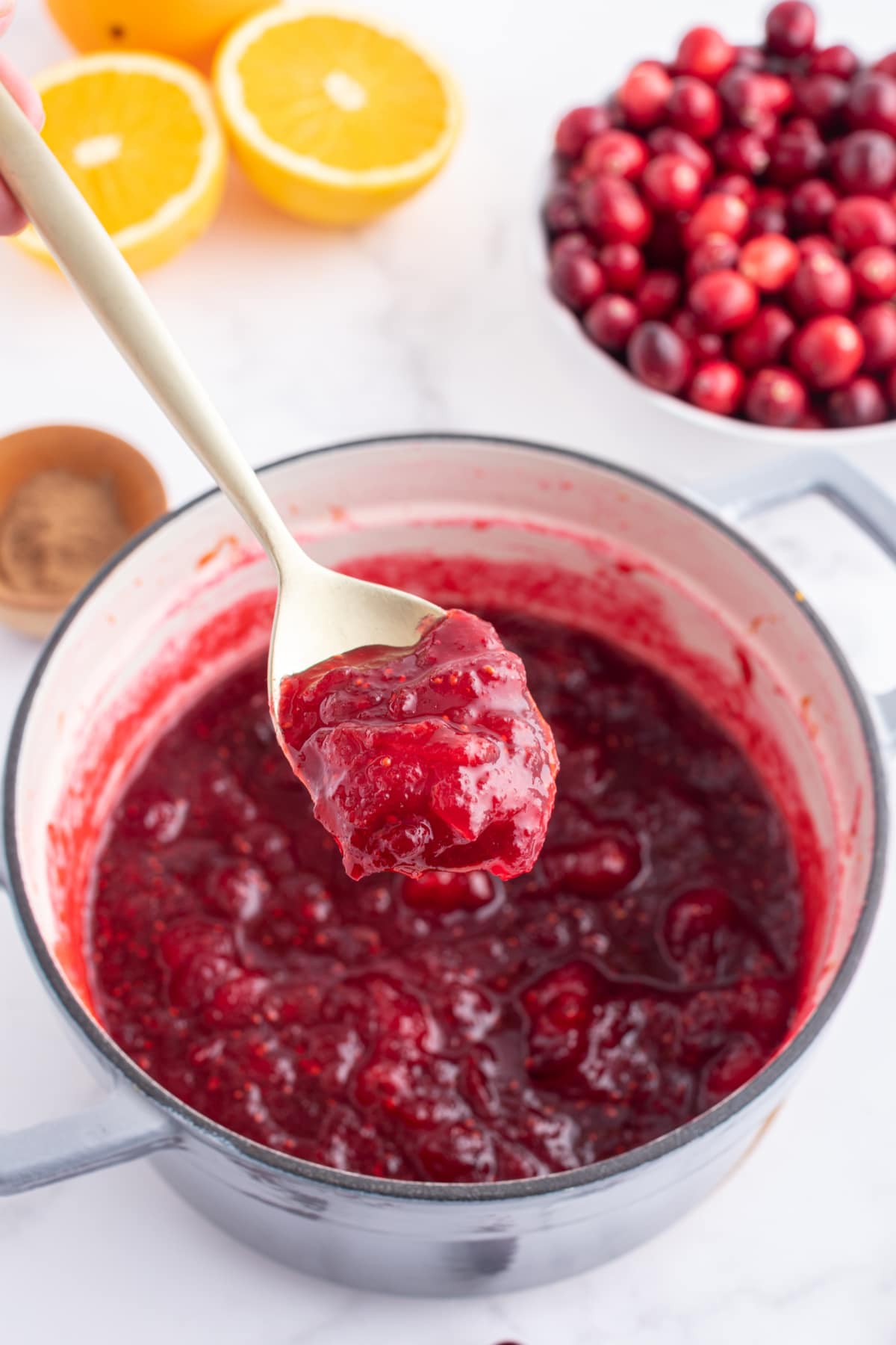 spooning out classic cranberry sauce out of pan