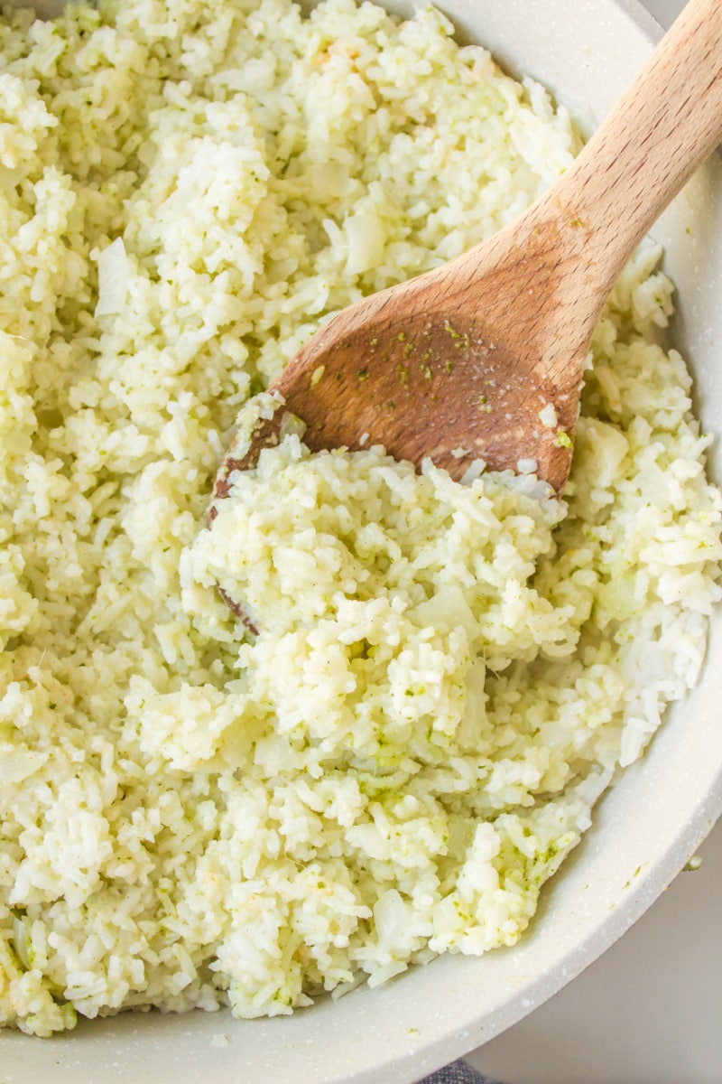 wooden spoon in a bowl of coconut ginger rice