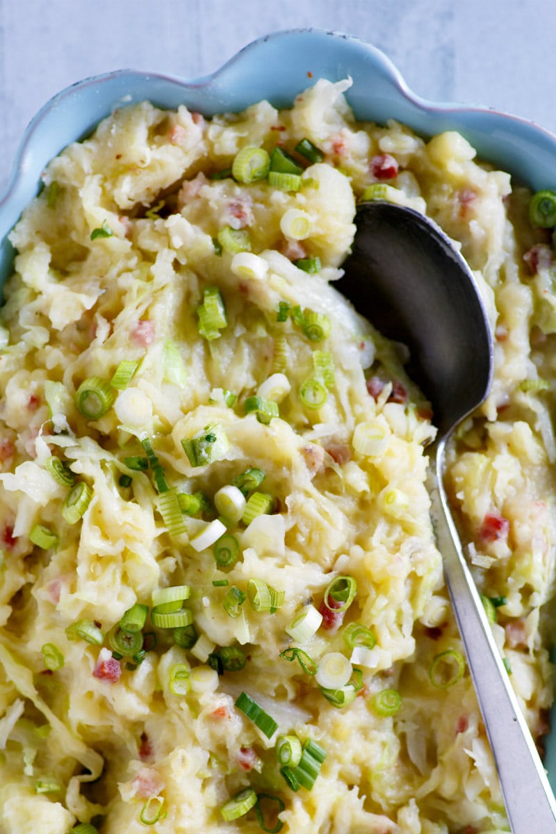 Traditional Irish Colcannon recipe from RecipeGirl.com #traditional #irish #colcannon #mashed #potato #potatoes #stpatricksday #recipe #RecipeGirl Colcannon in dish with spoon