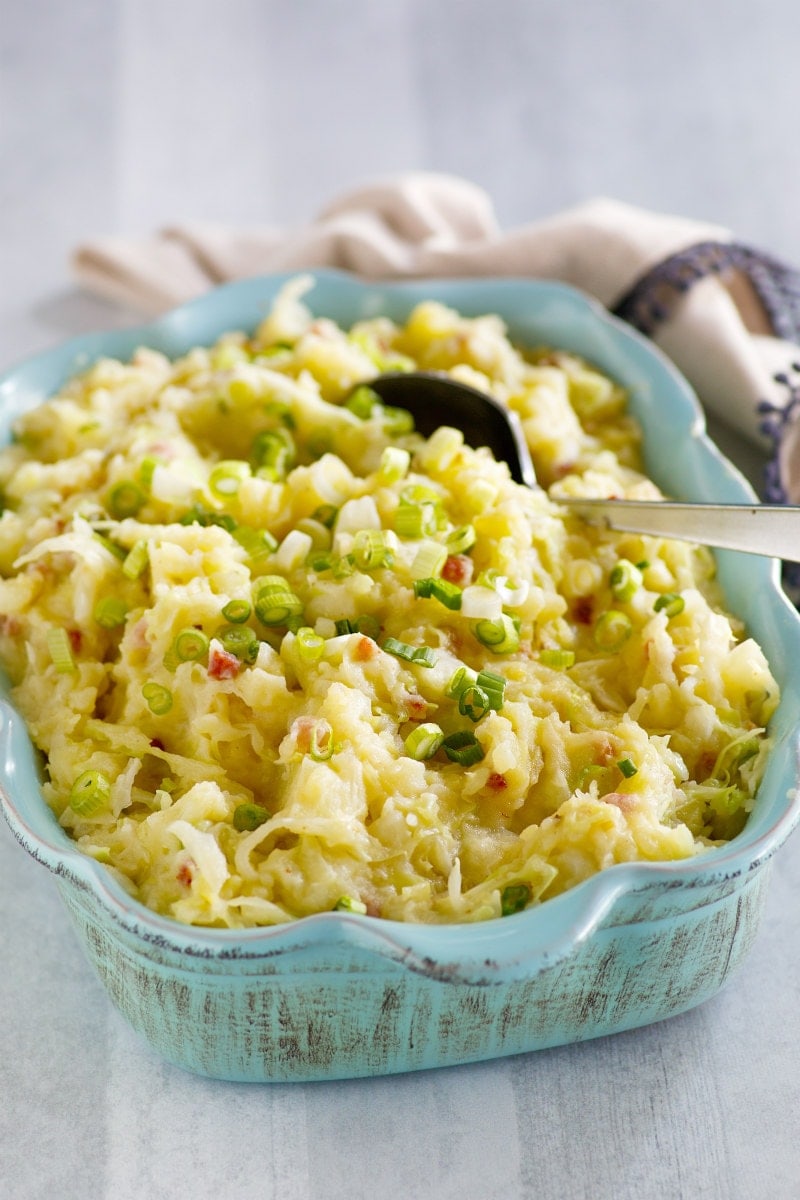 Traditional Irish Colcannon recipe from RecipeGirl.com #traditional #irish #colcannon #mashed #potato #potatoes #stpatricksday #recipe #RecipeGirl Colcannon in blue dish with spoon