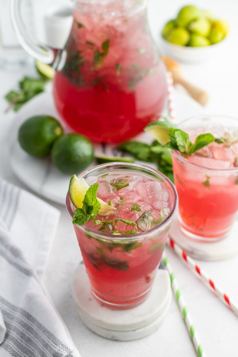 pitcher of cranberry mojitos with servings poured in glasses