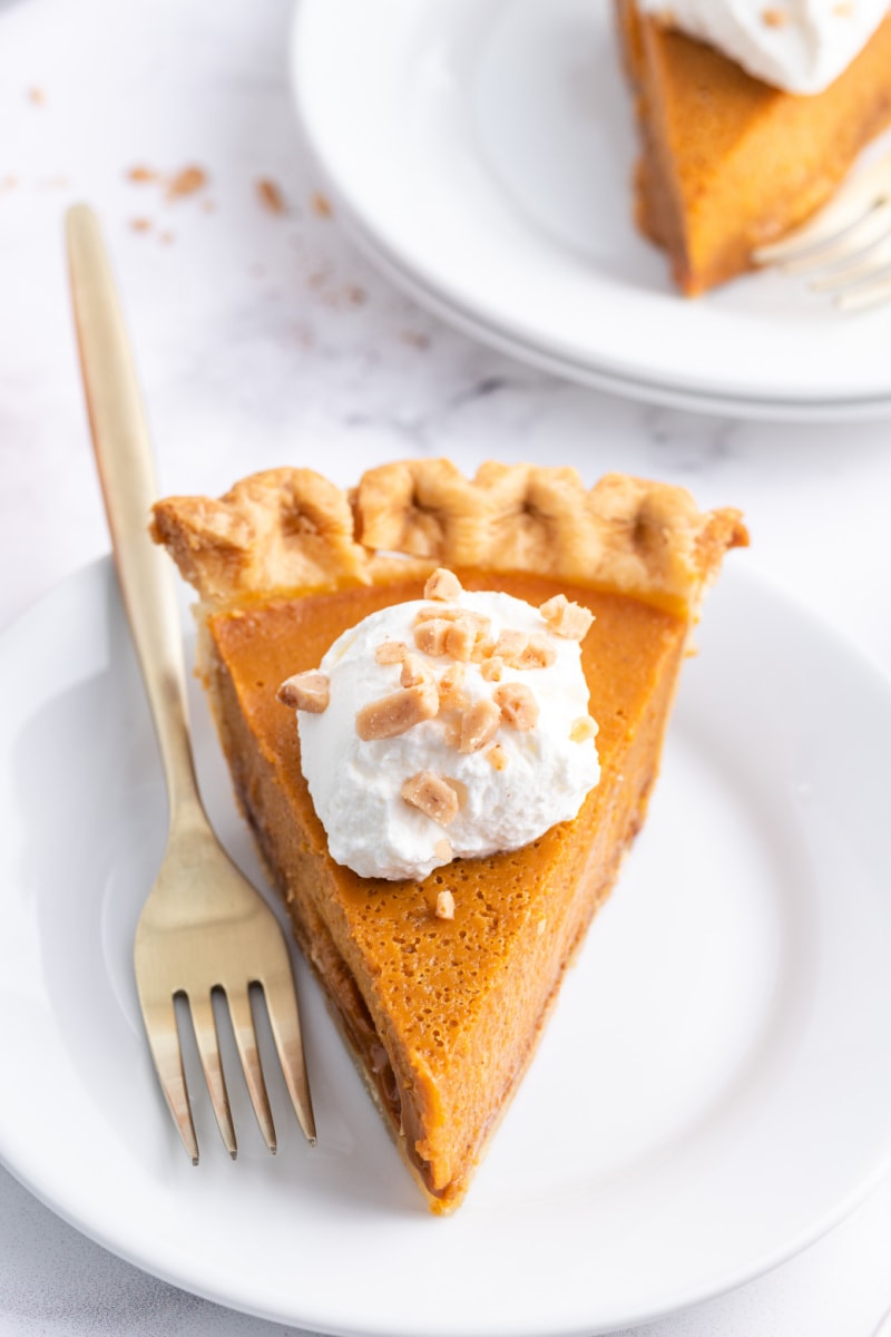 slice of pumpkin pie on a plate with a fork