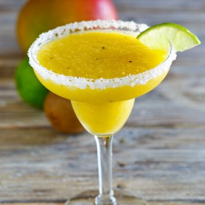 Tropical Margaritas in a margarita glass with lime wedge