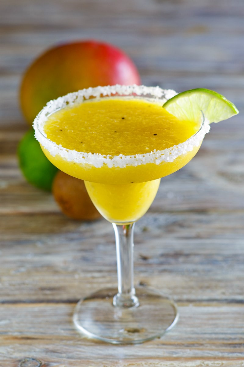 Tropical Margaritas in a margarita glass with lime wedge