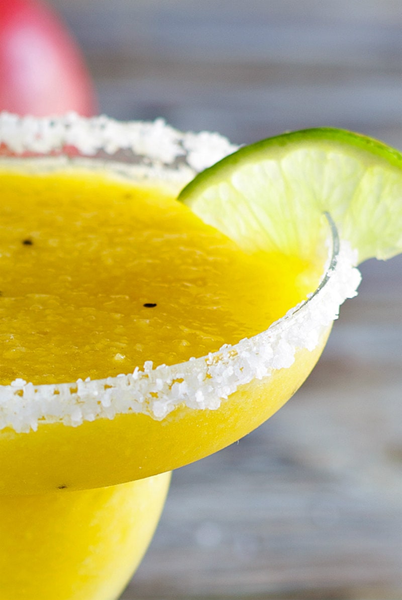 close up of tropical margarita with lime wedge