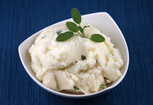 Creamy Mashed Potatoes with Goat Cheese and Sage in a white dish