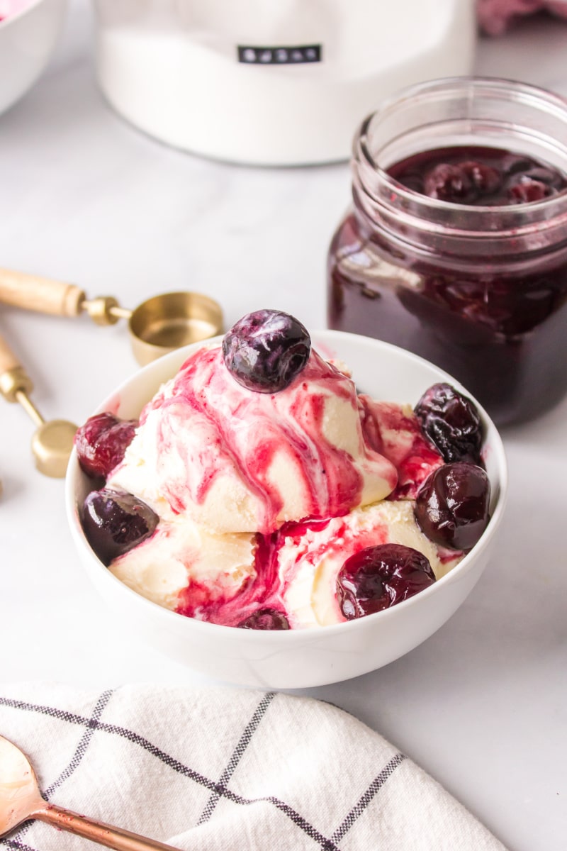 hot cherry sauce served over vanilla ice cream in bowl