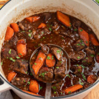 ladling out beef stew from pot