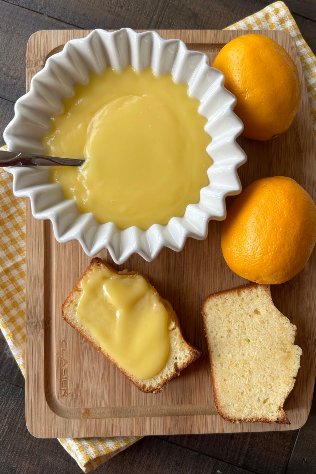 meyer lemon curd in bowl and slices of bread with lemon curd spread on