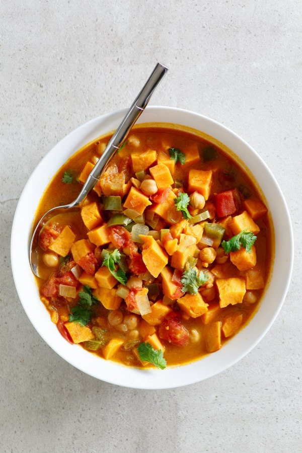 Moroccan Stew recipe from RecipeGirl.com #stew #comfortfood #vegetarian #sweetpotatoes #recipegirl Bowl of Moroccan Stew in a white bowl