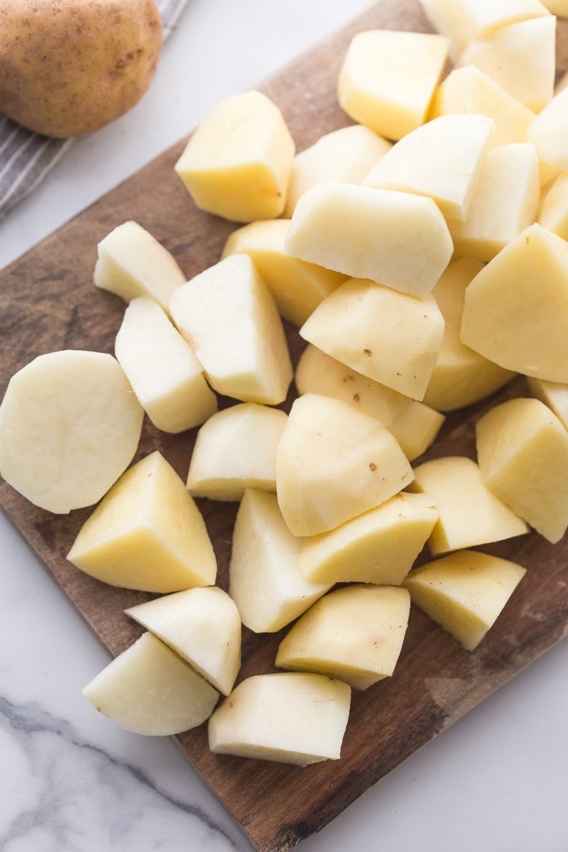 Potatoes peeled and cut on a cutting board