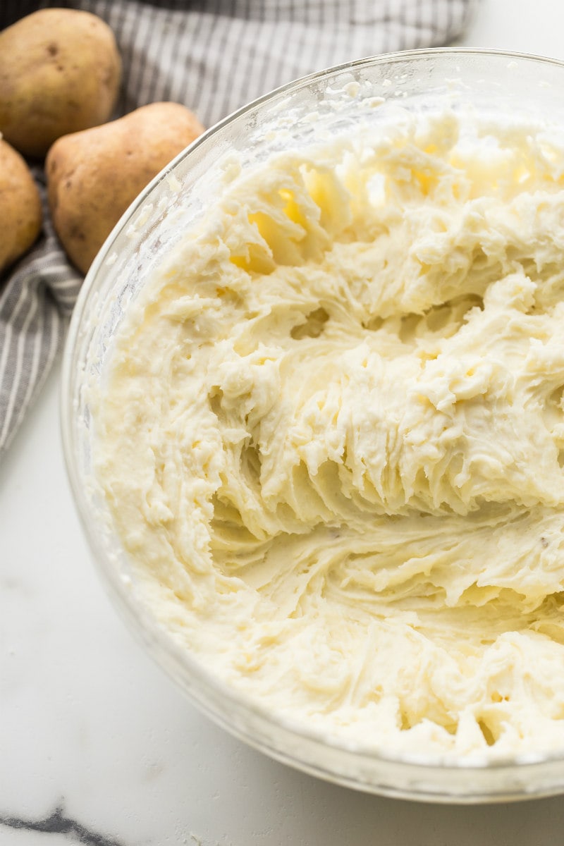 Blending potatoes to make mashed potatoes in a bowl